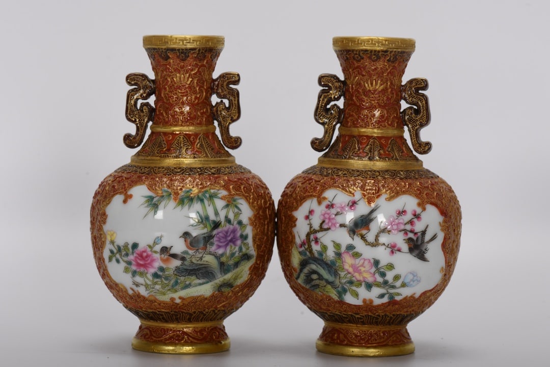 A Qing Dynasty Qianlong period enameled alum-red carved windowed flower and bird amphorae vase: Qing Dynasty, Qianlong period, enameled alum red carved windowed flower and bird two-ear vase, height 13.5 cm, mouth diameter 3.5 cm, belly diameter 8 cm, bottom diameter 4.2 cm. Provenance:Mrs. Amily