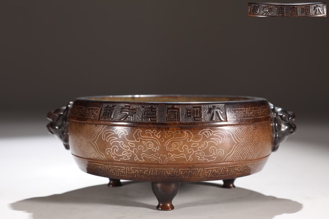 Copper-bodied inlaid silver taotie pattern lion head ear drum-shaped censer: A finely cast bronze censer with silver inlay, featuring taotie motifs and lion-head handles, dating from the Ming Dynasty. Dimensions: Height 7.5cm, Mouth Diameter 14.5cm, Belly Diameter 15.5cm, Hand