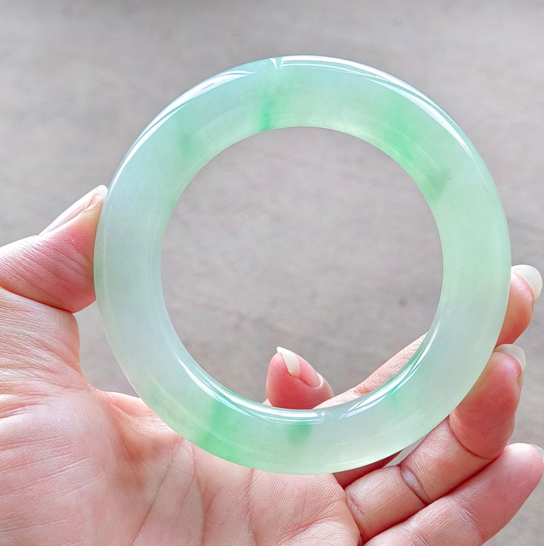 Dragon Stone Jadeite Bangle with Floating Flower Pattern: A dragon-stone type jadeite bangle with floating flowers, excellent translucency, absolutely perfect. Provenance:Mrs. Amily, Washington, DC. Our dedicated team expertly handles both domestic and globa