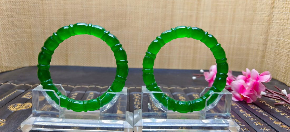 A pair of top-grade dragon stone emerald bamboo-shaped jadeite bangles: A pair of top-grade dragon stone emerald bamboo-shaped jadeite bangles, with excellent translucency and absolutely perfect. Provenance:Mrs. Amily, Washington, DC. Our dedicated team expertly handles b