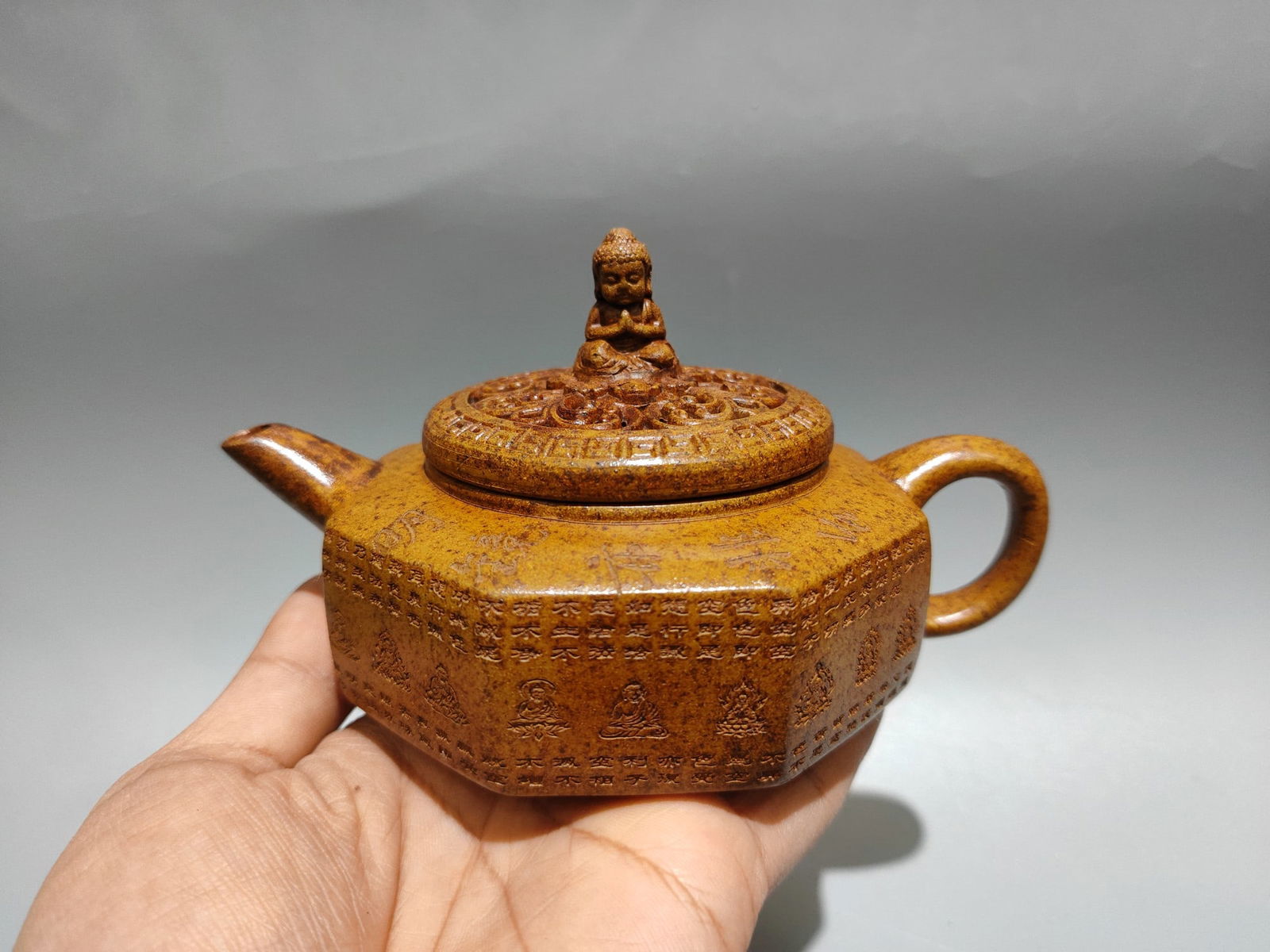 Product Name: Octagonal Openwork Buddhist Teapot: Product Name: Octagonal Openwork Buddha Teapot; Bottom Mark: Gu Jingzhou; Size: 16/10cm; Capacity: 280cc; Clay: Original Ore Dragon Bone Gold Sand Provenance:Mrs.Jennifer , Minneapolis, Minnesota. Col