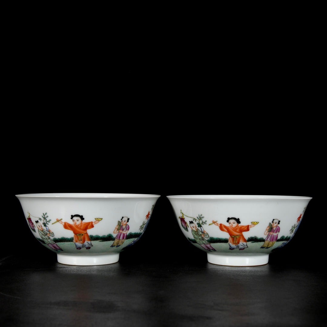 A pair of Qing Dynasty Qianlong period enamel porcelain bowls depicting figures and children at play (1 of 9)