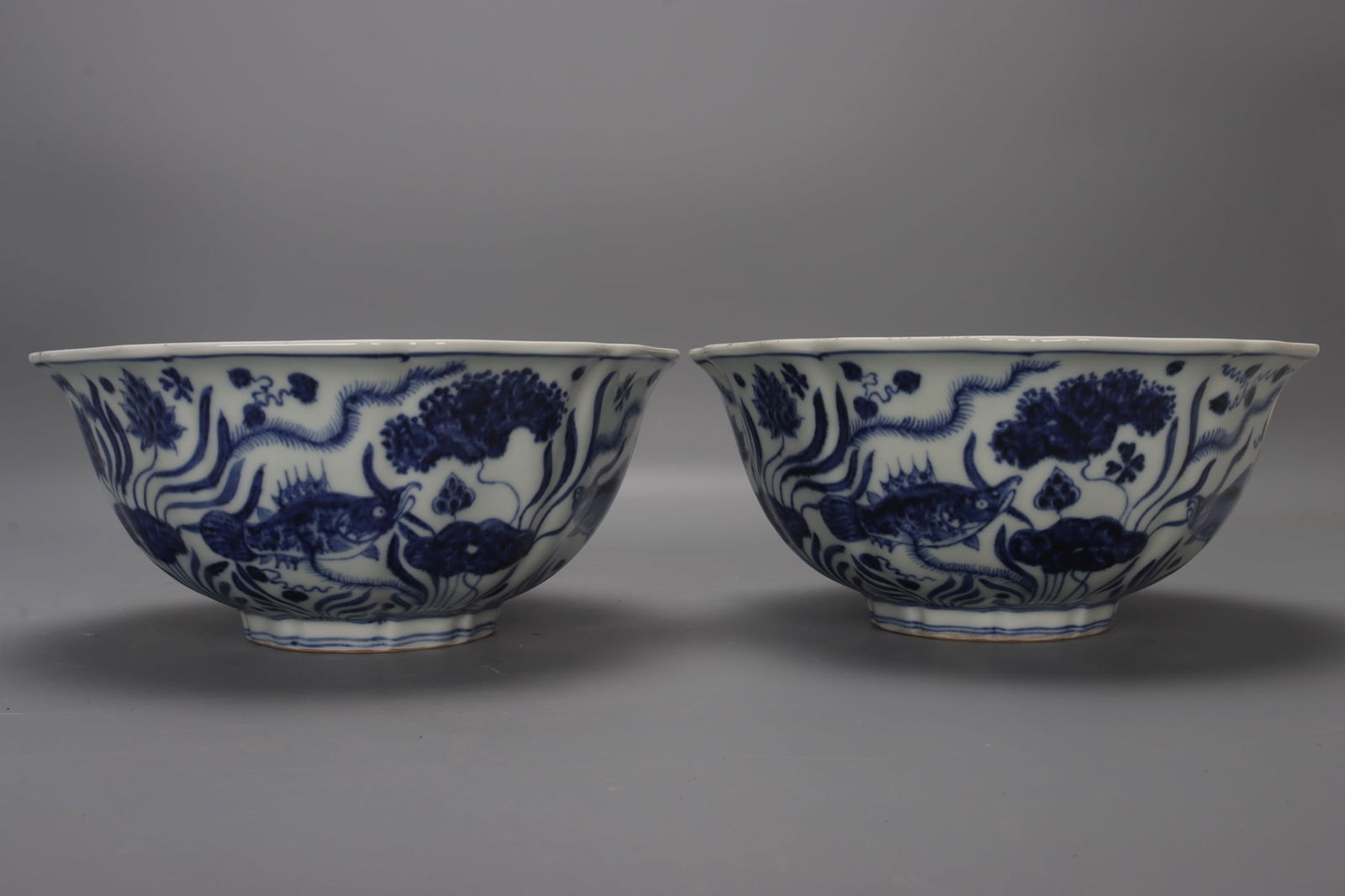 A pair of blue and white porcelain bowls with seaweed and fish motifs from the Xuande period of the (1 of 9)