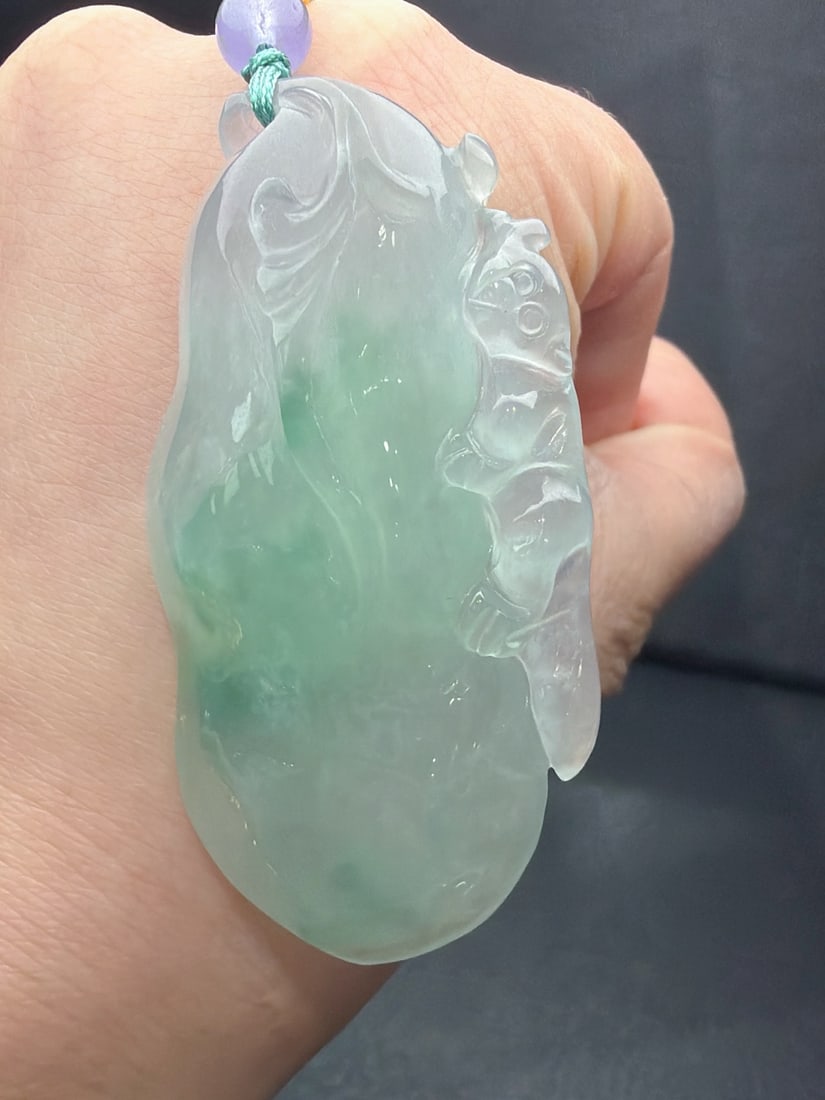 Jadeite of icy texture with floating patterns, symbolizing continuous advancement.: The jadeite, of the icy type with floating patterns, is named "Rising Step by Step." It is translucent and lustrous, finely carved, thick and full, with excellent texture and translucency. Provenance: