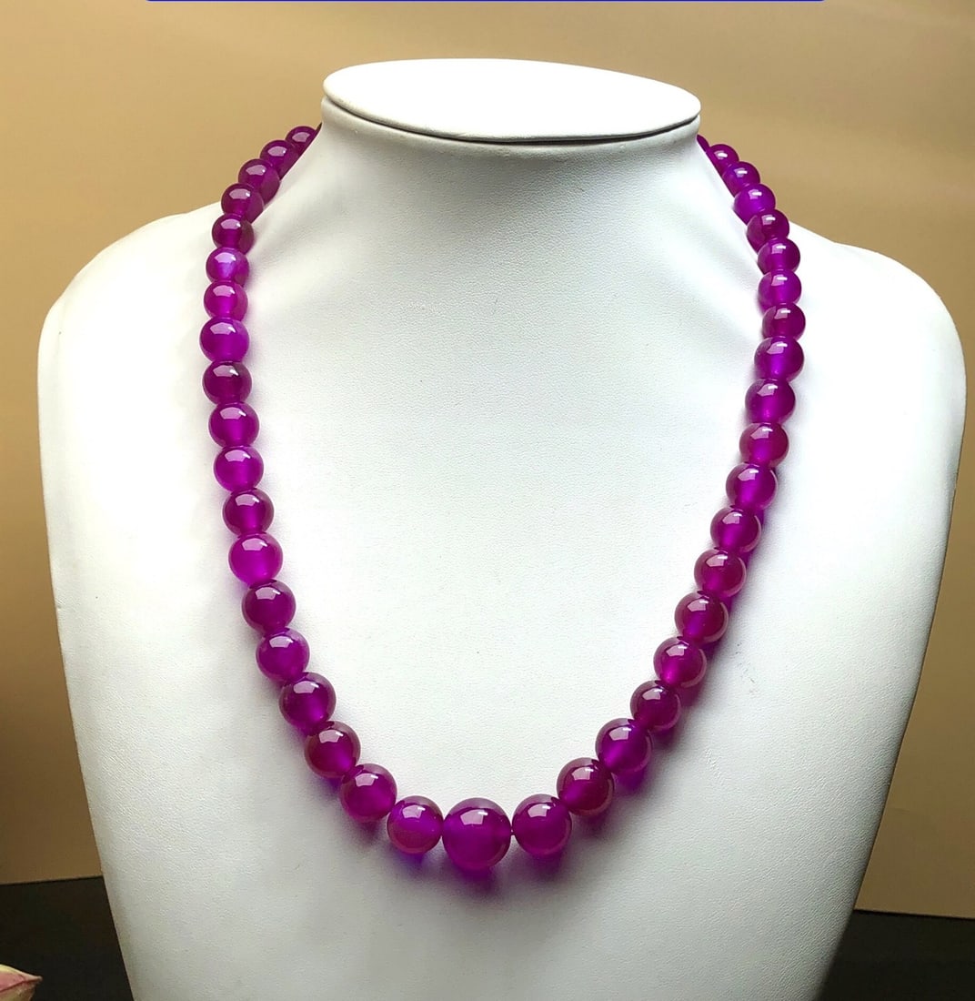 High-Ice Red Jadeite Tower Bead Necklace: This high-quality, icy red jadeite pagoda bead necklace is made from superior materials. It is icy, translucent, and lustrous, with full color and a beautiful finish. It is in perfect condition. Prove