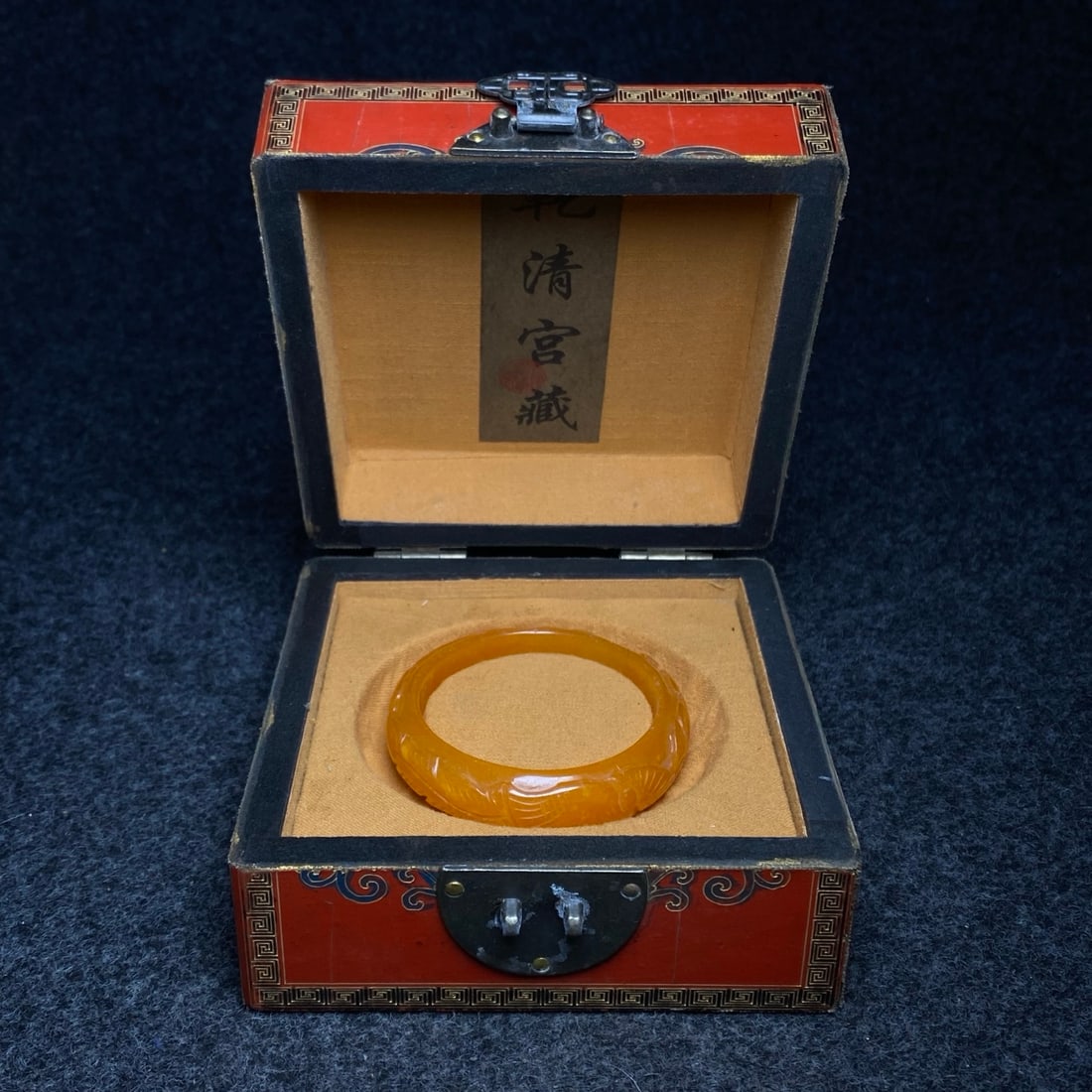 A jade-carved bracelet is found inside a box containing imperial dragon-patterned lacquerware. (1 of 10)
