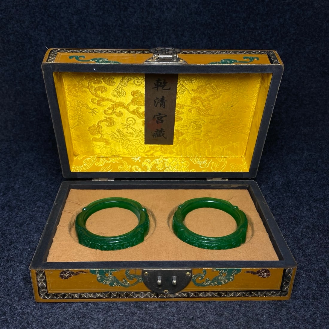 A jade bracelet with intricate carvings is found inside a lacquerware collection box made by the (1 of 10)