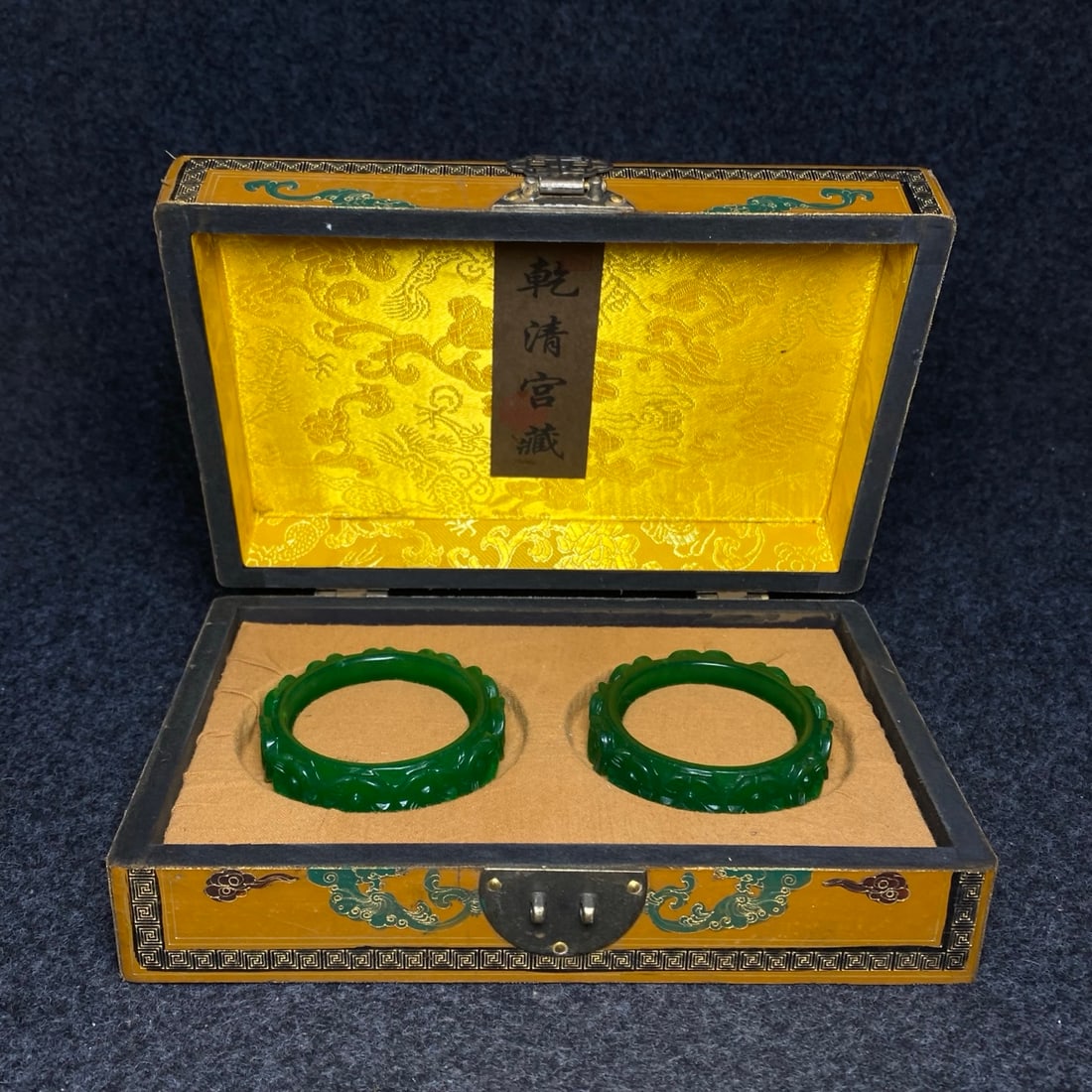 A jade bracelet with intricate carvings is found inside a lacquerware collection box made by the (1 of 10)