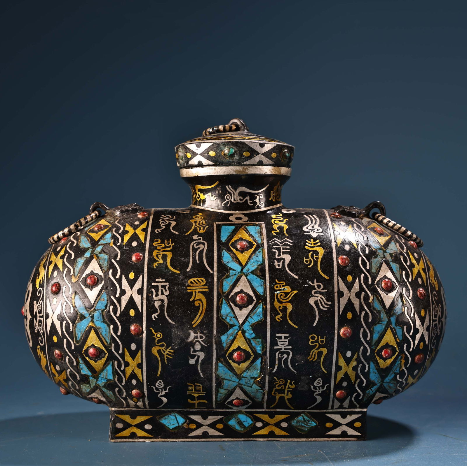 Bronze Jar with Gold and Silver Inlay and Gemstone Inlay and Turquoise Cover: Bronze covered jar inlaid with gold and silver, gemstones, and turquoise. Exquisite craftsmanship and beautiful design. Weighs 1400g. Height 14cm, Width 20cm. Provenance:Mrs. Amily, Washington, DC. Ou
