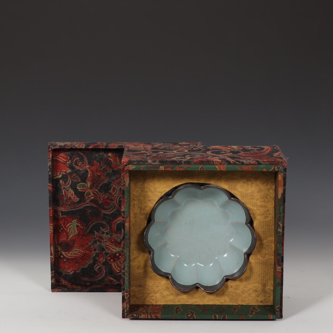 Formerly in the collection of a Song Dynasty Ru ware celadon-glazed silver-rimmed lotus petal washer: A Song Dynasty Ru ware celadon-glazed washer with a silver rim and imperial inscription, formerly in the collection. Dimensions: Height 5.8cm, Diameter 17.5cm. Provenance:Private collection, Connectic