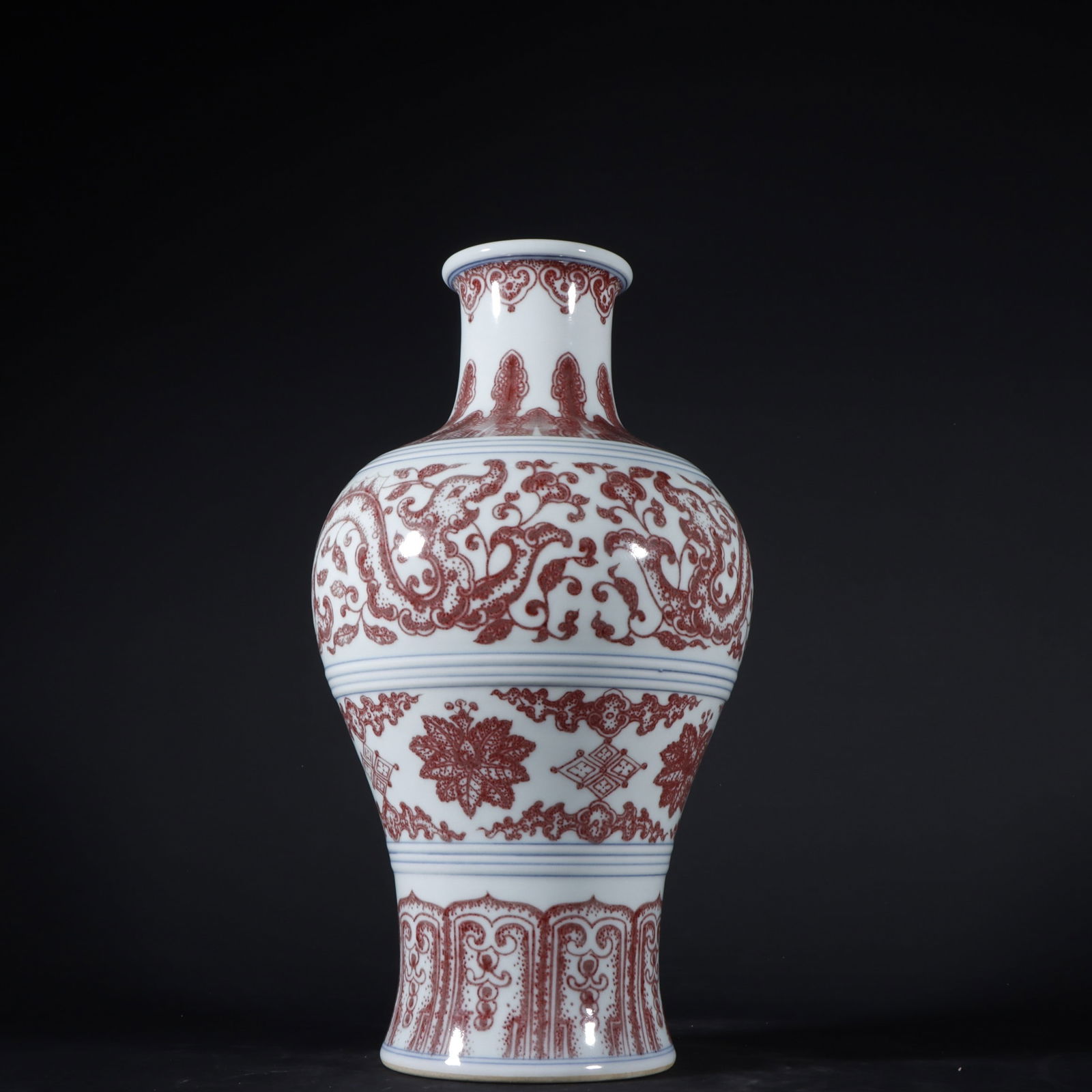 A Qing Dynasty Qianlong period underglaze red vase with kui dragon and floral design. (1 of 9)