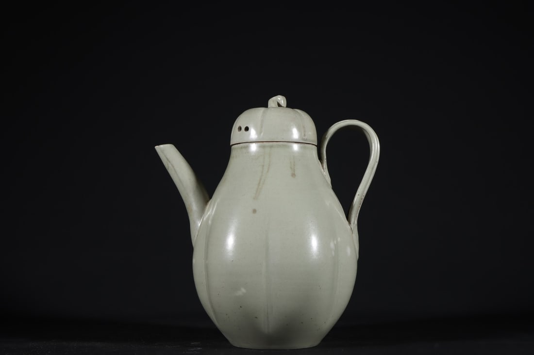 Formerly in the collection of a Yue ware celadon teapot from the Tang and Five Dynasties period. (1 of 9)