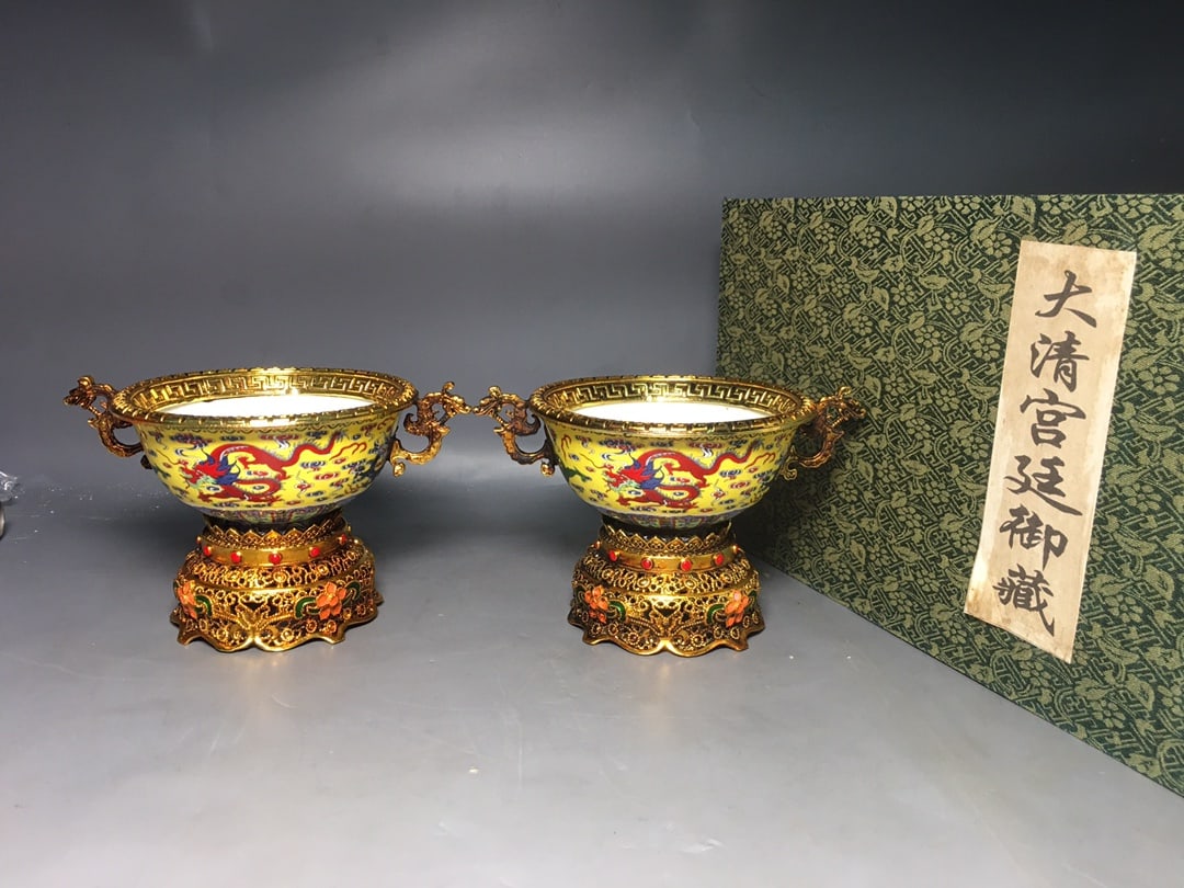 A Qing Dynasty Qianlong period cloisonne enamel bowl with a gold-plated ground and famille rose: A Qing Dynasty Qianlong period cloisonne enamel bowl with a gold-plated ground and famille rose dragon design, measuring 13.2 x 18 x 11 cm. Provenance:Mr. Stefan, Minneapolis, Minnesota. Our dedicated