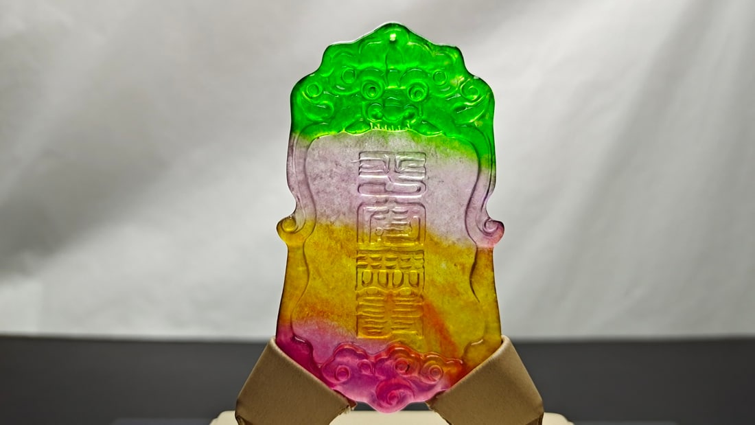 Top-grade dragon stone type, multicolored, extra-large jadeite "peace charm" pendant: A top-grade, multicolored, extra-large jadeite "peace charm" pendant made from a single piece of jade, with excellent translucency and is absolutely perfect. Provenance:Private collection from a profe