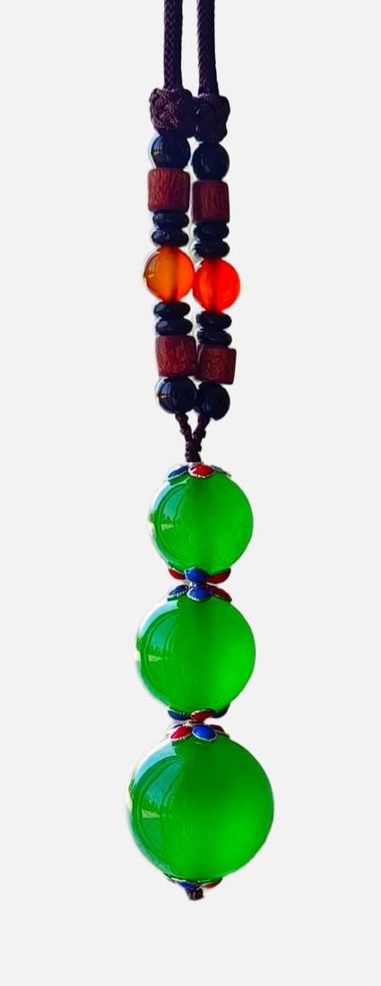 Top-grade Dragon Stone Imperial Green Jadeite Pendant with Fortune, Prosperity and Longevity Symbols: Top-grade imperial green jadeite pendant with auspicious symbols of fortune, prosperity, and longevity, made from dragon-stone variety. Excellent clarity and flawless. Provenance:Mrs. Blair, Newport B