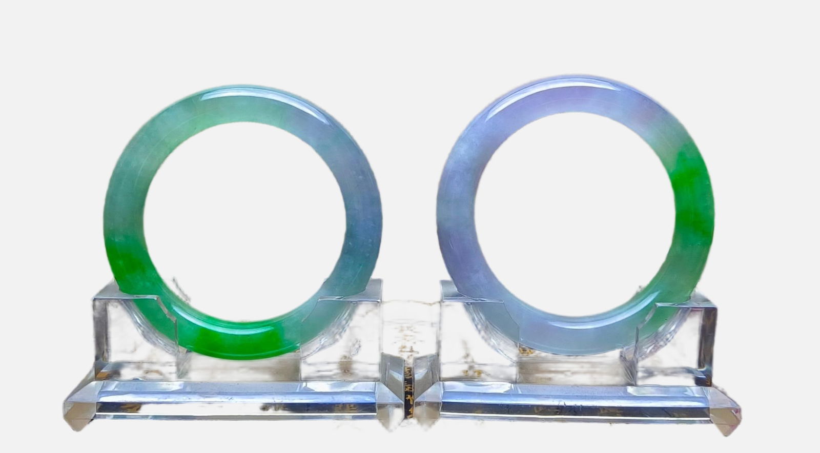 A pair of dragon-stone jadeite bracelets with floating flowers: A pair of dragon-stone jadeite bangles with floating flowers, excellent translucency, absolutely perfect. Provenance:Private Estate, Michigan. Our dedicated team expertly handles both domestic and glo