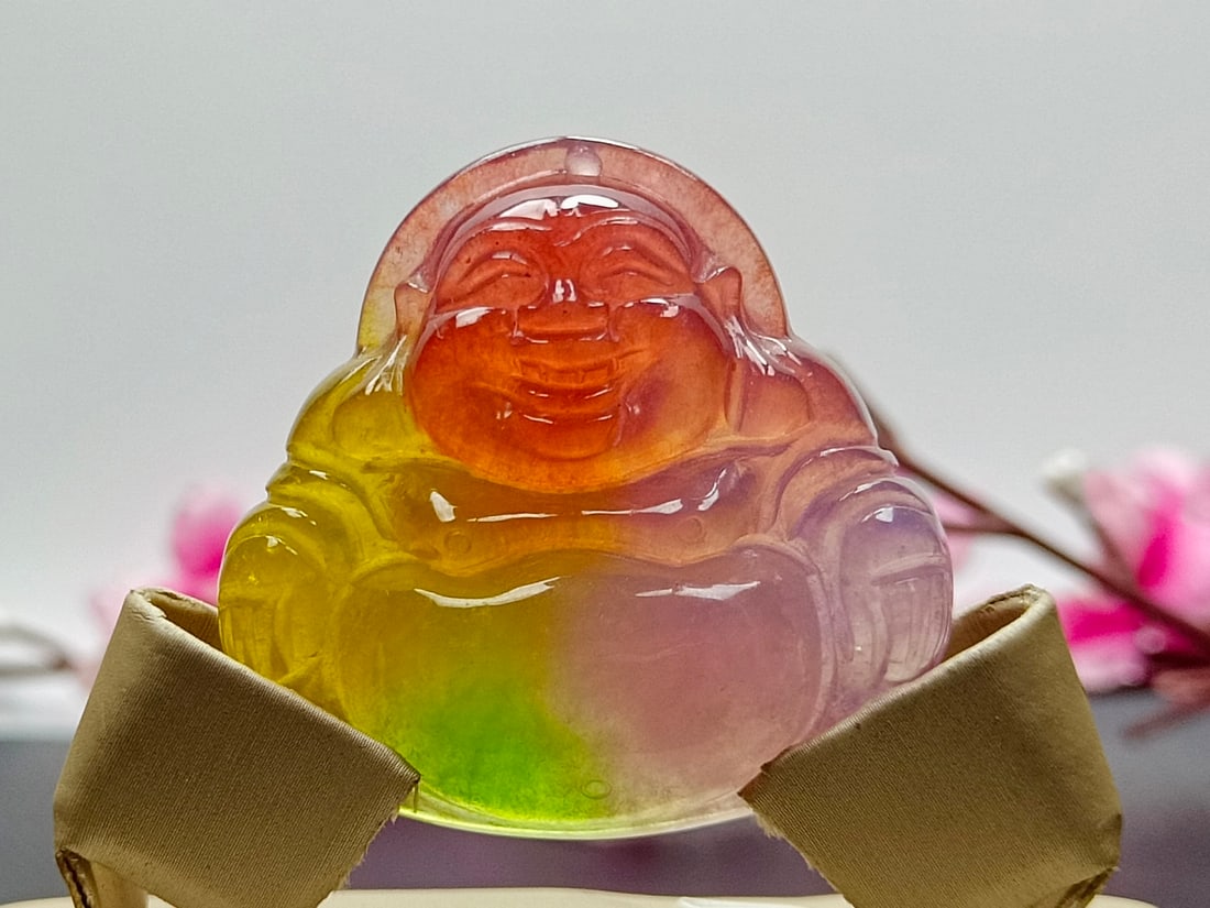 Top-grade dragon stone type colorful jadeite Maitreya Buddha pendant: Top-grade dragon stone jadeite Maitreya Buddha pendant, carved from a single piece of jade, with excellent translucency and is absolutely perfect. Provenance:Private Estate, San Diego, California. Our