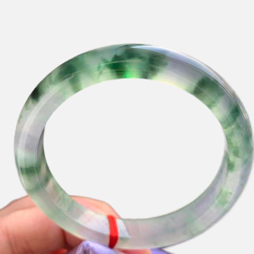 Burmese jadeite bangle with high icy texture and floating green patterns.: This is a small-mouthed jadeite bangle from Myanmar, featuring high-quality icy jadeite with floating green flowers. The jadeite is of fine texture, old variety, and looks very beautiful on the wrist.