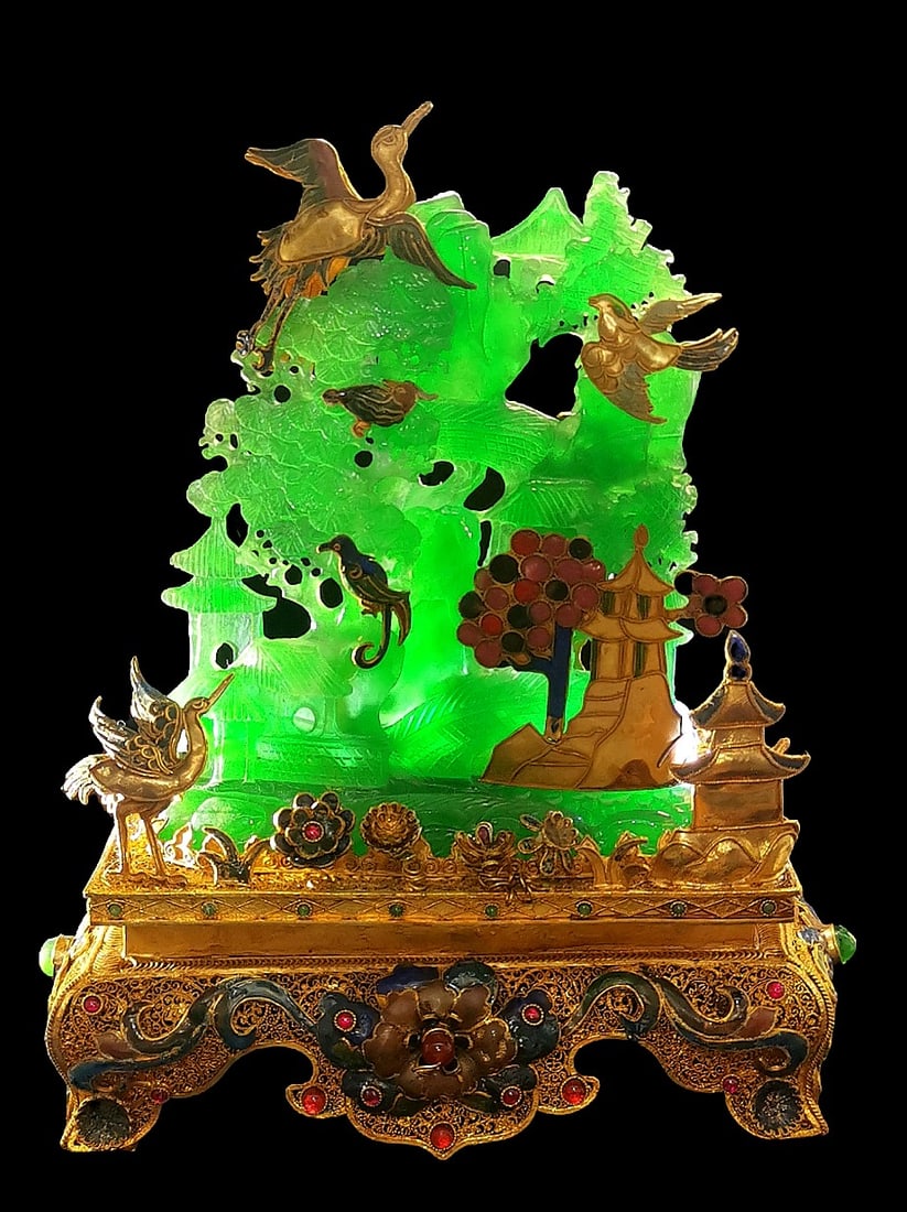 A rare enamel-painted gilt bronze miniature mountain inlaid with high-quality icy porcelain.: This is a rare enamel-painted, gilt-bronze, high-quality jadeite miniature mountain carving. It is well-preserved, simple and elegant, with a light green background, full of charm. The craftsmanship i