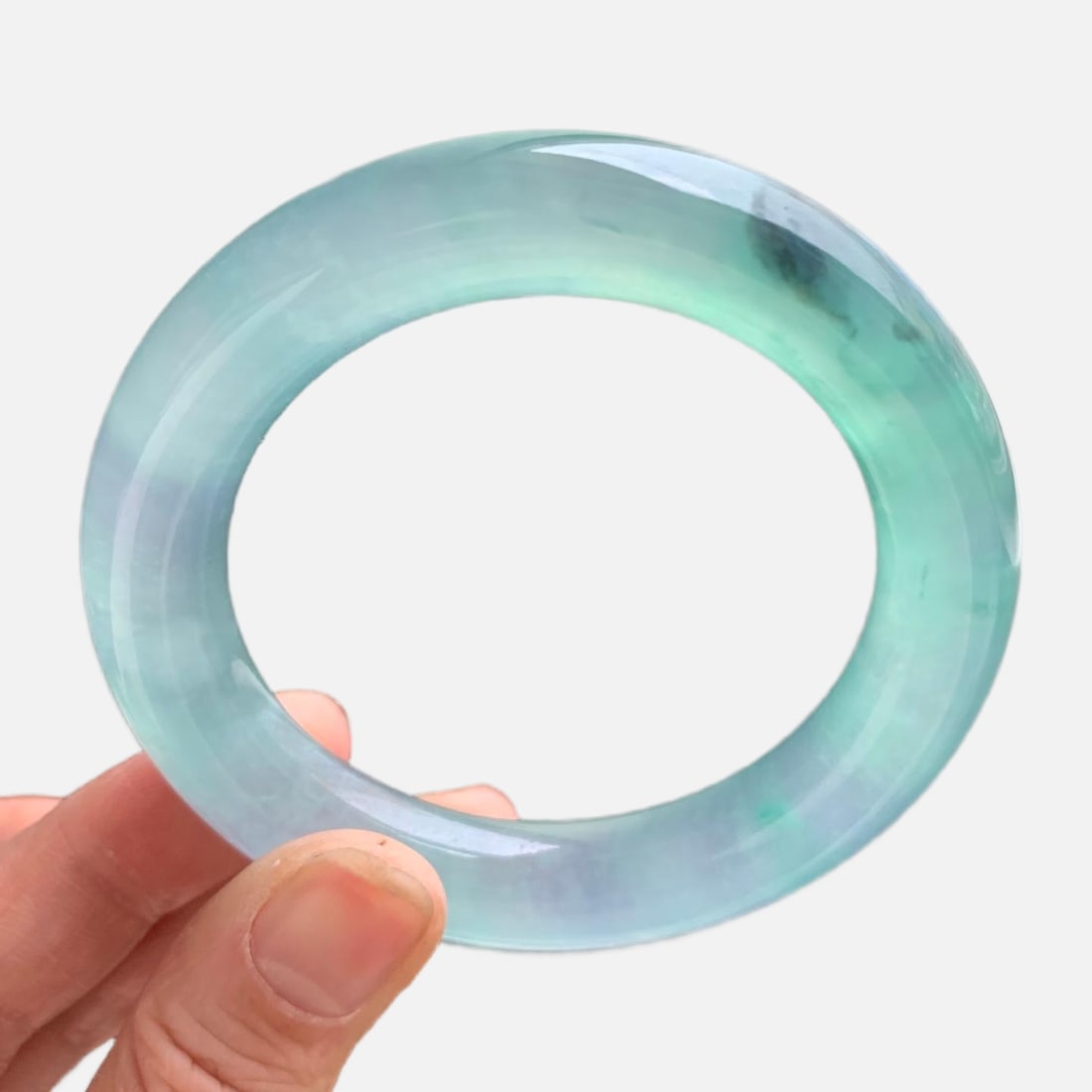 Burmese jadeite high-grade icy green with floating patterns, round bangle: This is a high-quality Burmese jadeite bangle, featuring a lake-green color with floating patterns. Made of Burmese jadeite, it is of icy quality, with fine texture and old jadeite deposits. It looks