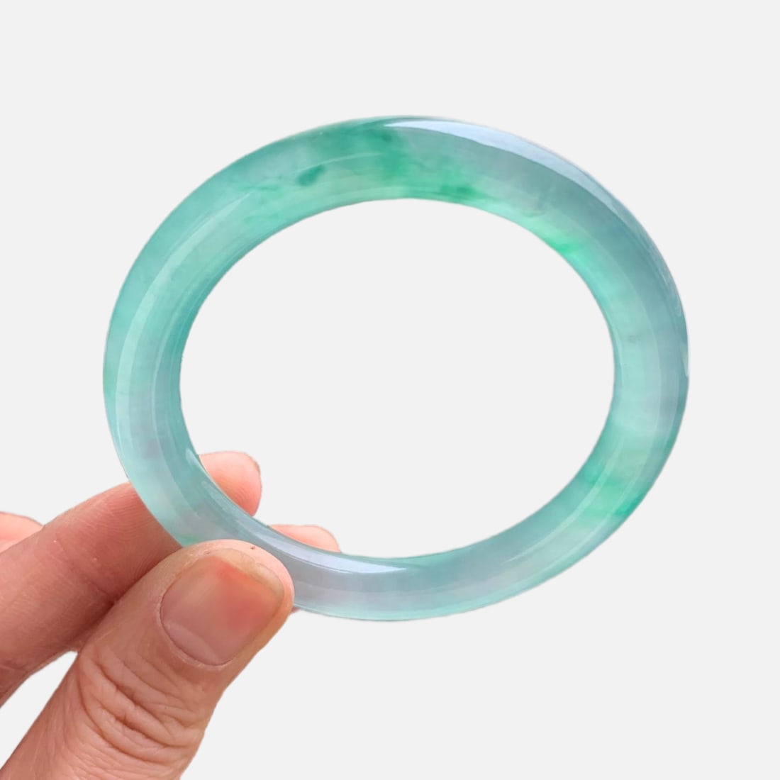 Burmese jadeite high-grade icy green with floating patterns, round bangle: This is a high-quality Burmese jadeite bangle, featuring a lake-green color with floating patterns. Made of Burmese jadeite, it is of icy quality, with fine texture and old jadeite deposits. It looks