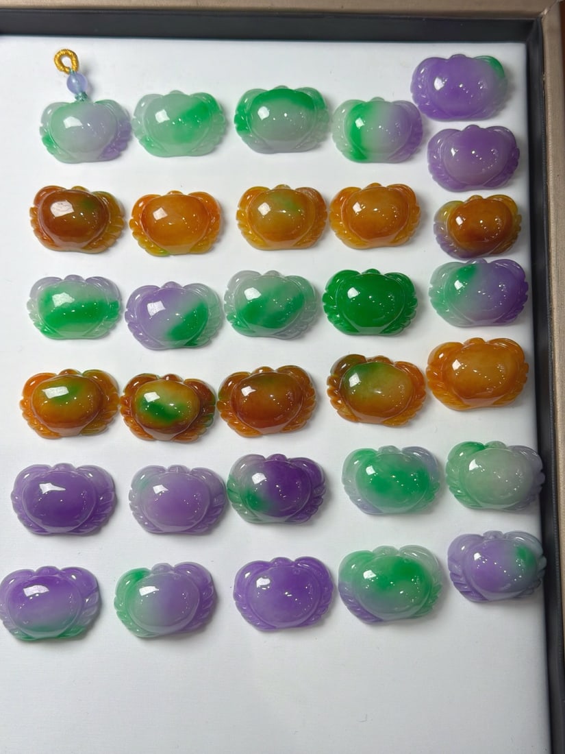 A colorful jadeite crab of glutinous texture, symbolizing wealth coming from all directions.: The jadeite of the glutinous type with multiple colors, depicting a "crab symbolizing wealth from all directions," is fine-grained, thick, and full. Provenance:Private collection, Middletown, Rhode Is