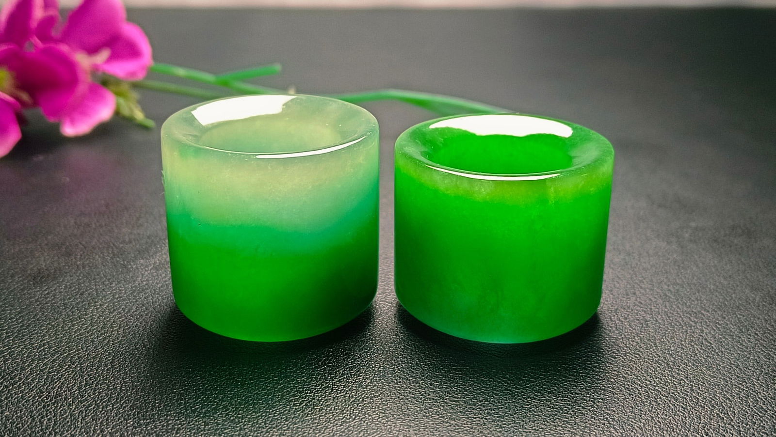 A pair of dragon-stone type bright green jadeite thumb rings (1 of 8)