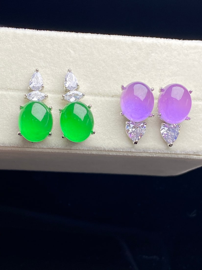 Jadeite of icy quality, full of green, and violet-colored "earrings": The jadeite earrings are of icy green quality, with a smooth and translucent appearance, exquisite and three-dimensional design, and flawless without any cracks. Provenance:Private collection, Vancouv