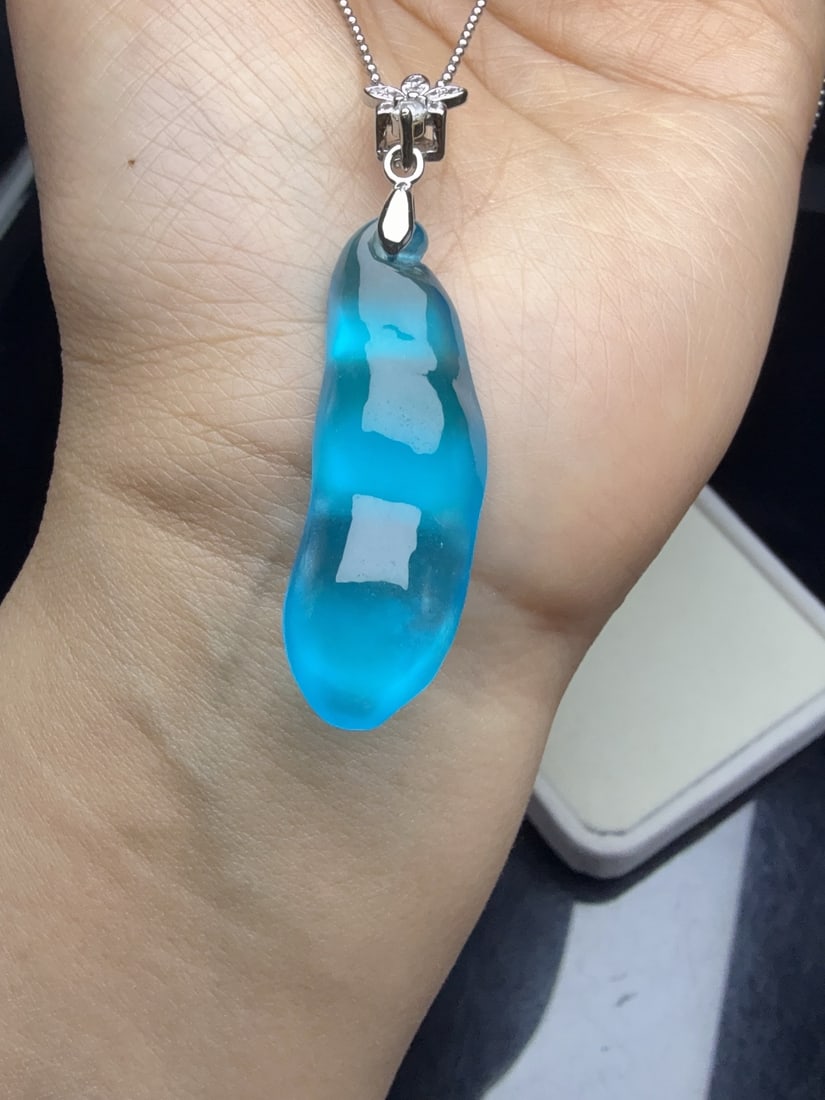 Jadeite of icy blue-green variety, resembling a lucky bean. (1 of 9)