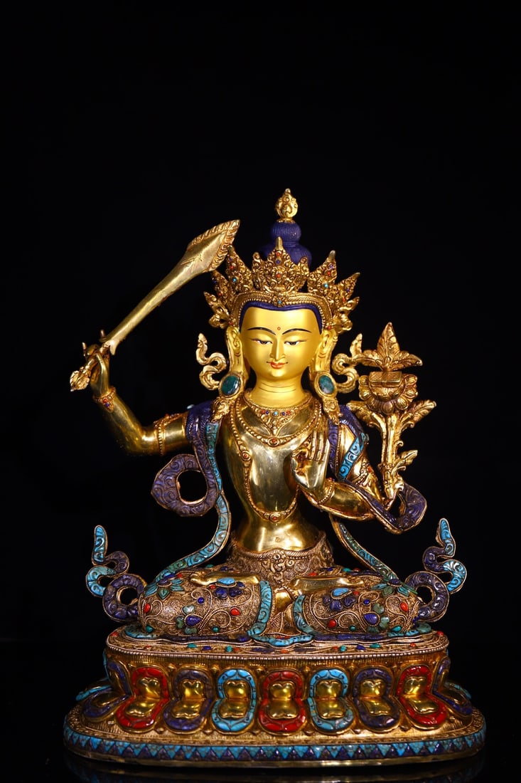 A handcrafted Manjushri Bodhisattva figure made of copper base, hand-carved, filigree, and inlaid: A handcrafted Manjushri Bodhisattva figure, handmade from Tibetan copper and engraved with Tibetan silver filigree and gemstones, measuring 46 cm in height, 36 cm in width, and weighing approximately