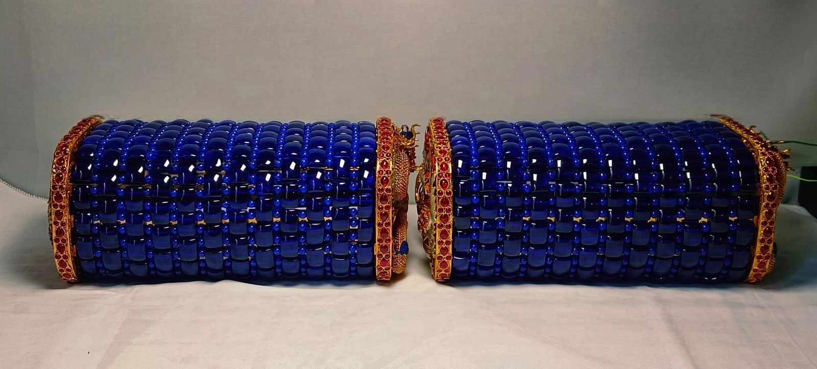 Gold-plated dragon and phoenix auspicious sapphire pillow: pair of sapphire pillows with gold-plated dragon and phoenix designs, measuring 28 x 15 cm, with a firmness of 10 and a weight of 3450 g. Provenance:From a private collection in San Diego, California,