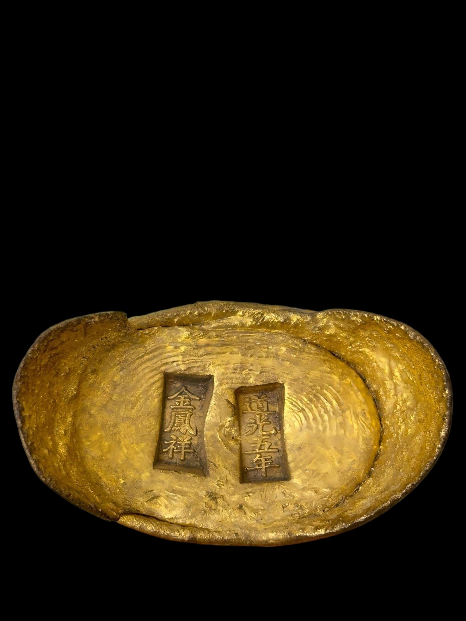 A Lao Feng Xiang gilded ingot: A gilded ingot from Lao Feng Xiang, dated to the seventh year of the Daoguang Emperor's reign, measuring 7.3 x 4.4 x 4.5 cm and weighing 406 g. Provenance:Mr. Stefan, Minneapolis, Minnesota. Our dedic