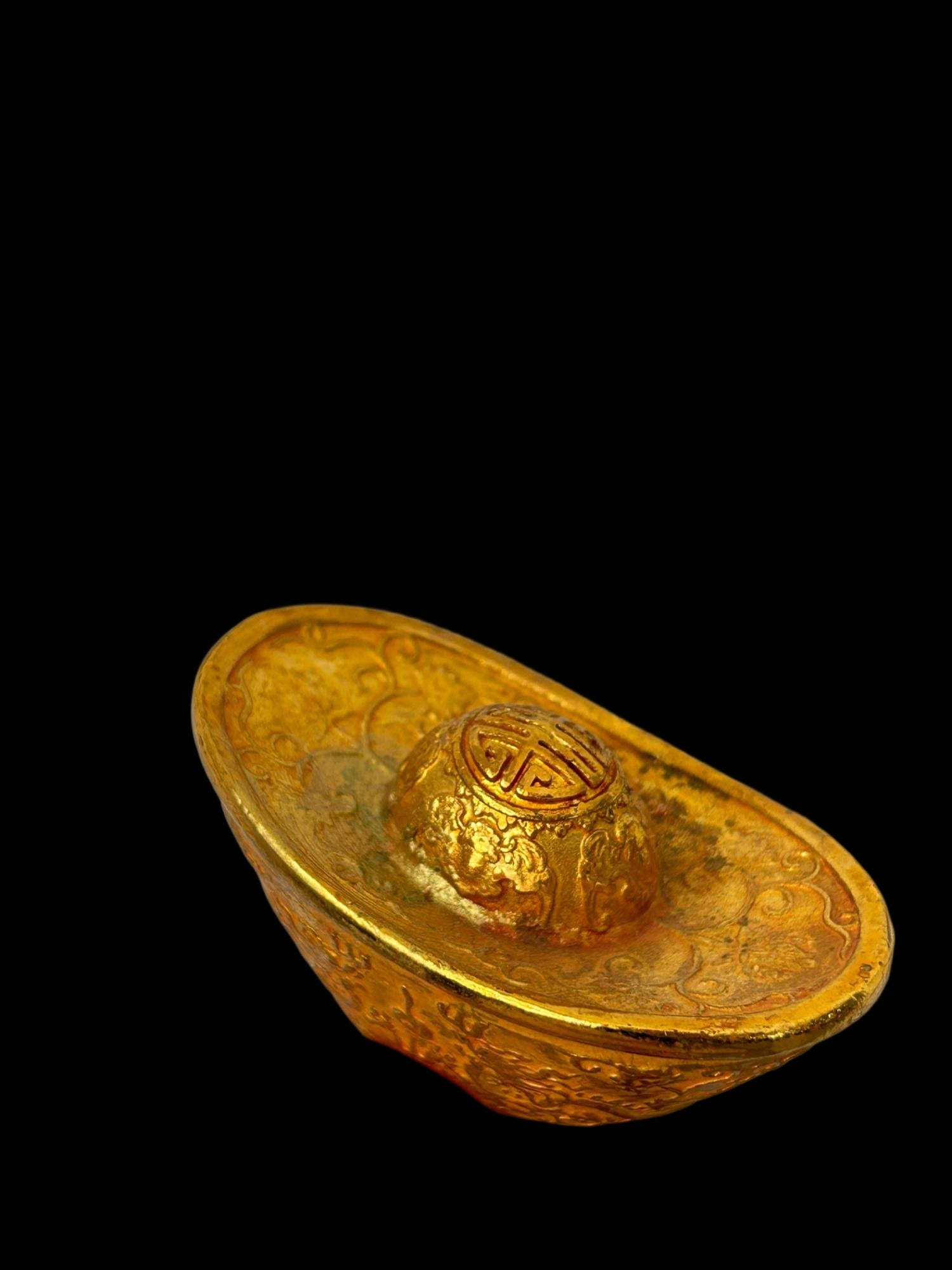 A gilt gold ingot with a double dragon playing with a pearl design and Qianlong reign mark. (1 of 9)