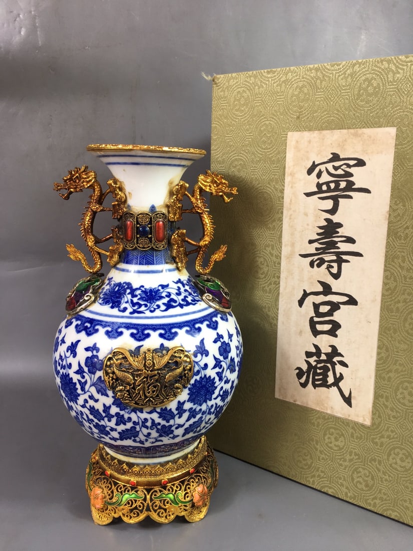 A rare Qing Dynasty cloisonne enamel and gold-plated blue and white porcelain vase with lotus scroll: rare Qing Dynasty cloisonne enamel and gold-plated blue and white vase with lotus scroll design, measuring 8x15x28cm. Provenance:Mrs. Blair, Newport Beach, California. Our dedicated team expertly hand