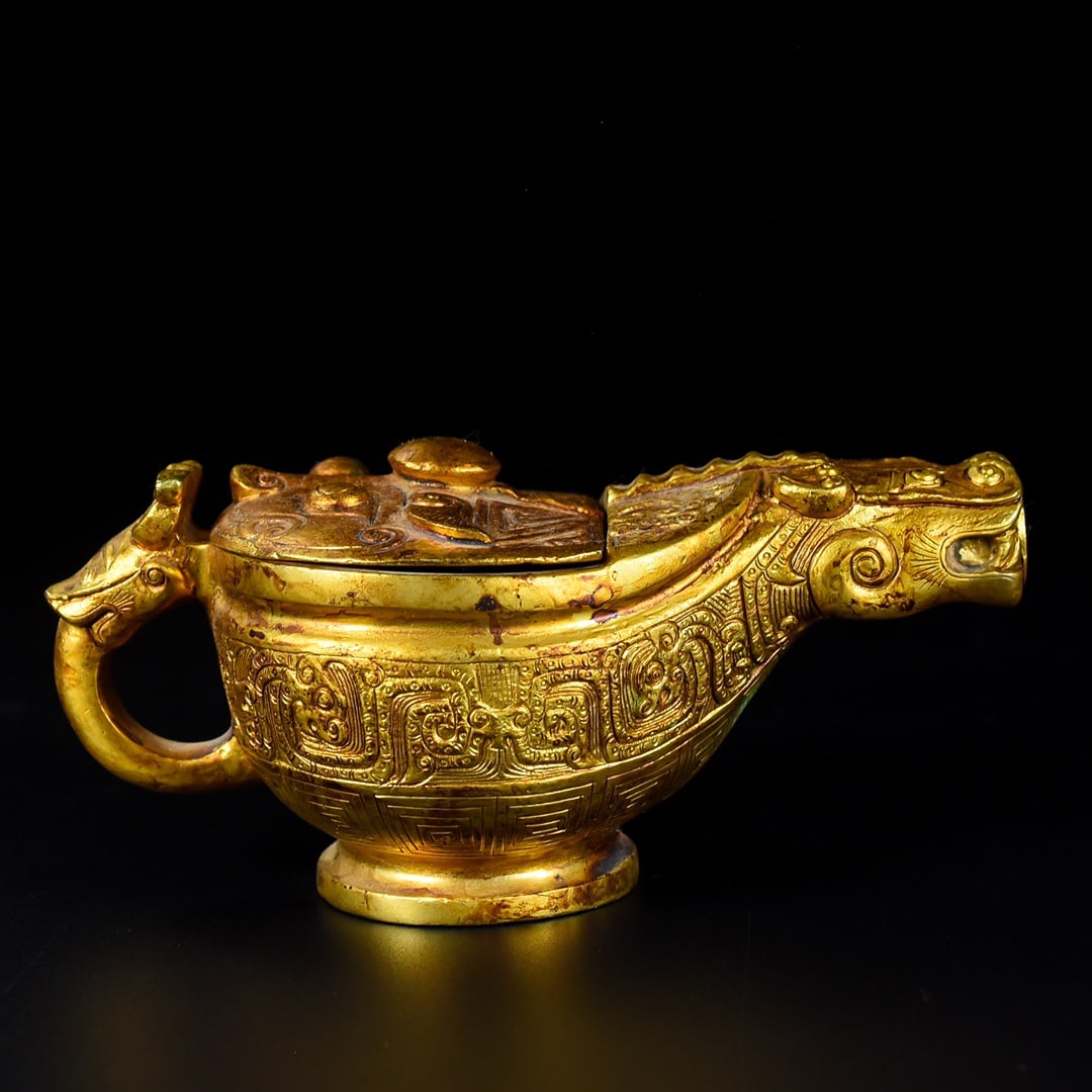 Formerly owned gilt bronze Han Dynasty handled pot: A gilt bronze Han Dynasty handled pot, formerly in the collection. It has a regular shape and smooth lines. It weighs 755 grams, is 6 cm high, and is 14 cm wide. Provenance:Private collection,