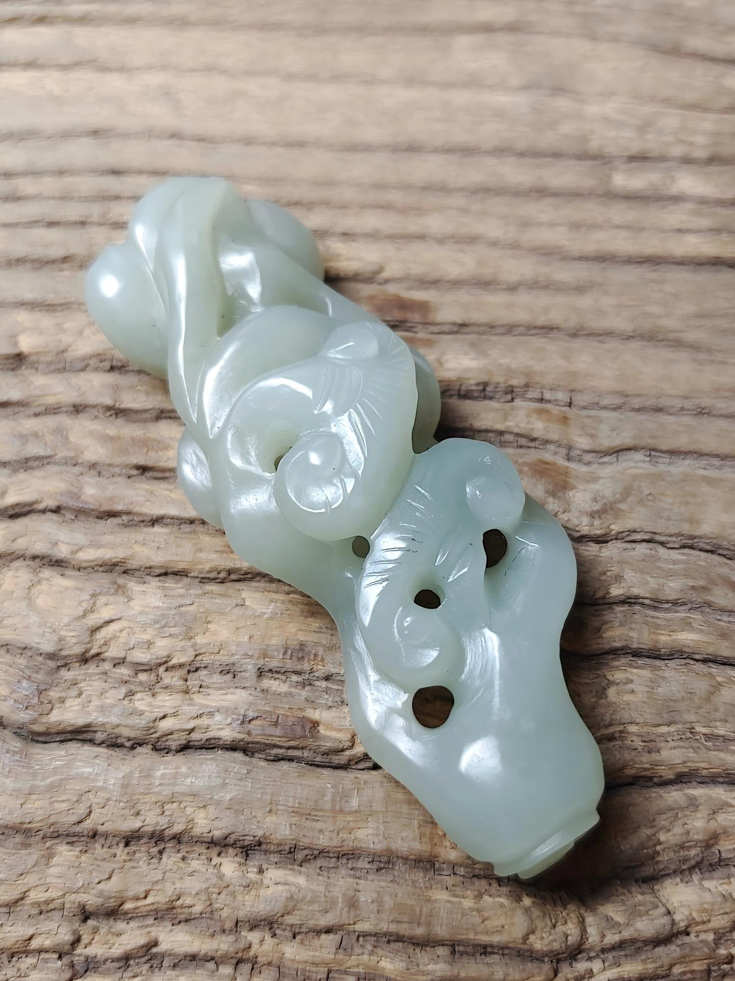 Hetian jade carving of a ruyi (a type of scepter): This Hetian jade ruyi-shaped carving measures 7.3cm in length, 2.5cm in width, and 1.6cm in thickness, and weighs 33.1g. Provenance:Private collection, Cliffside Park, New Jersey. Our dedicated team e