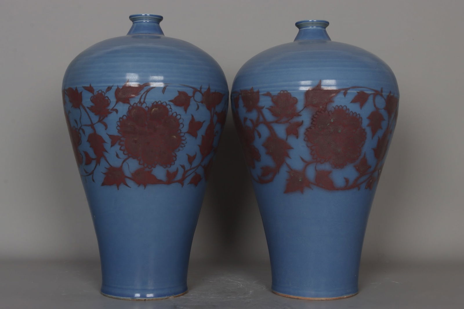 A pair of Yuan dynasty sky-blue glazed underglaze red lotus scroll plum vases (1 of 9)