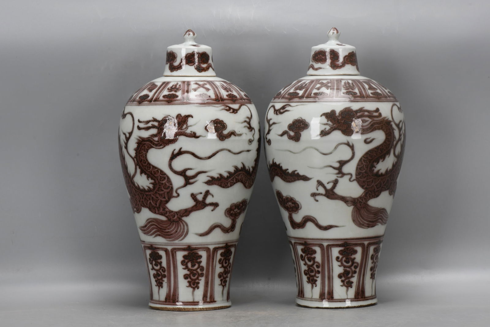 A pair of Yuan Dynasty underglaze red plum vases with eight treasures and cloud and dragon design (1 of 9)