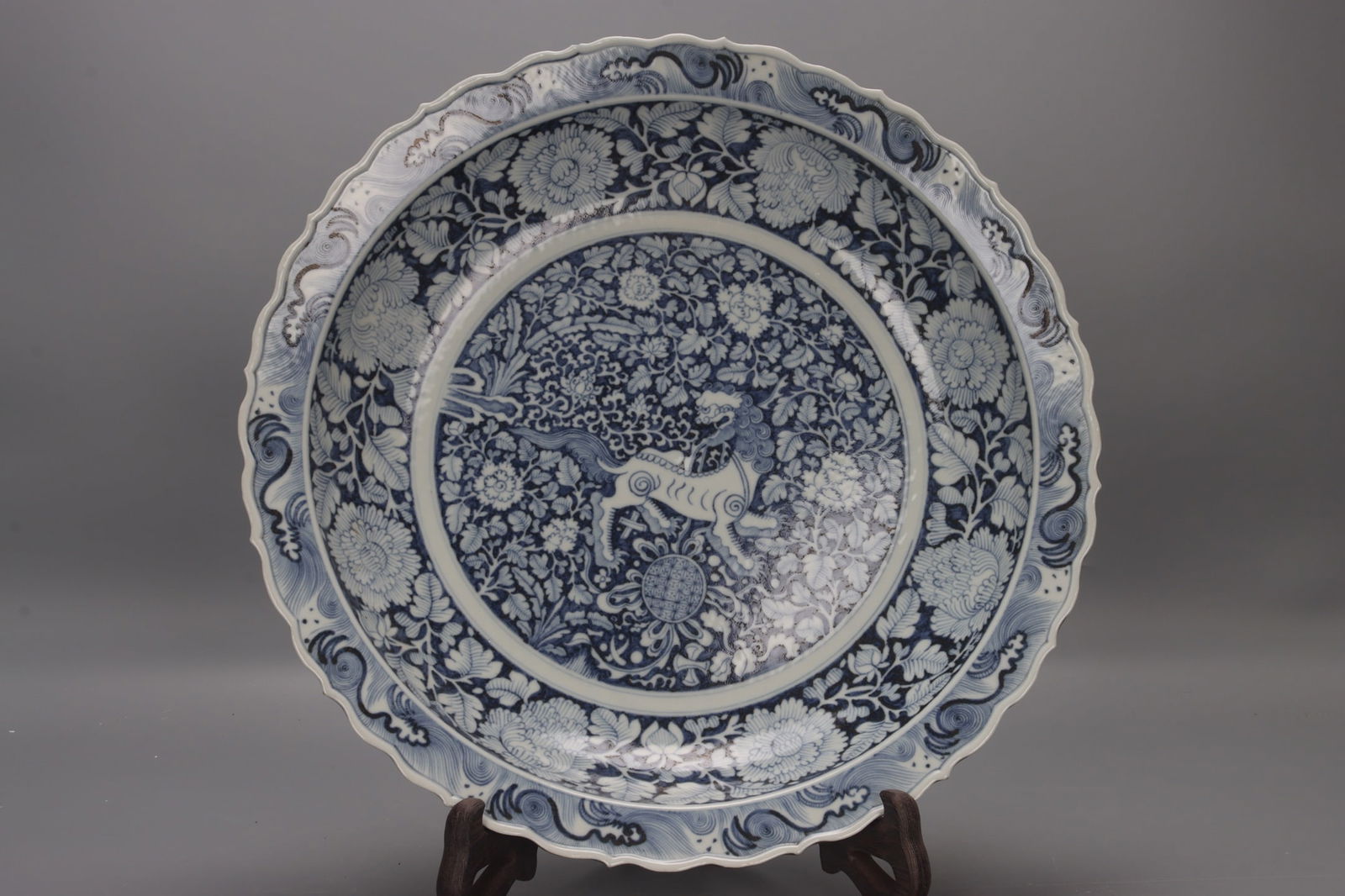 A Yuan Dynasty blue and white porcelain plate with lotus and lion motifs. (1 of 9)