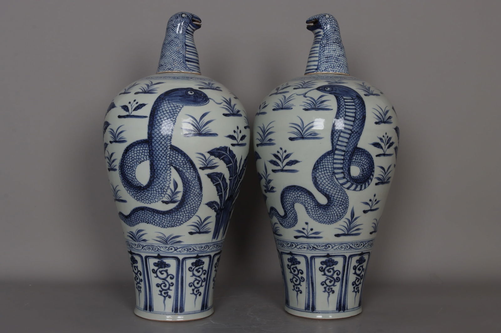 A pair of Yuan Dynasty blue and white porcelain plum vases depicting a snake startled by grass. (1 of 9)