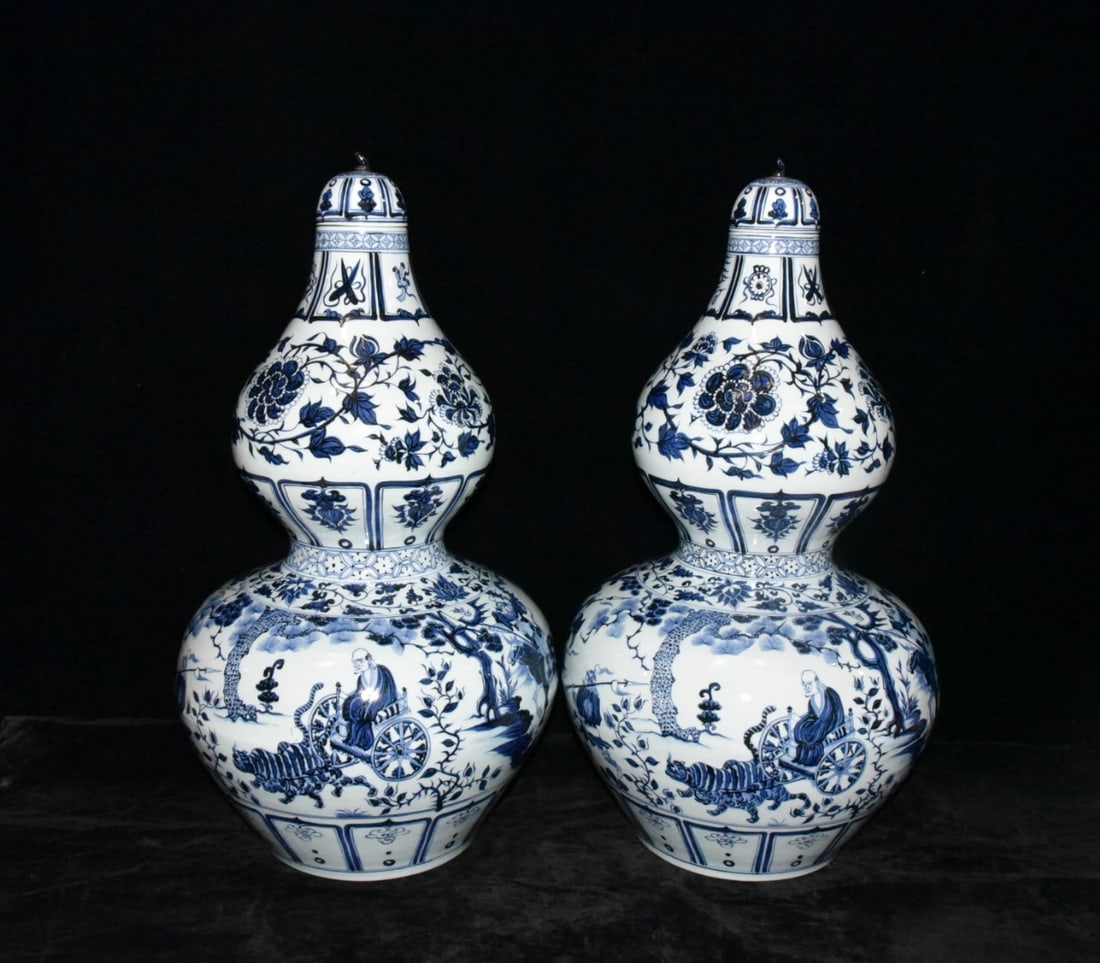 A pair of Yuan Dynasty blue and white porcelain gourd-shaped vases depicting Guiguzi descending the (1 of 9)