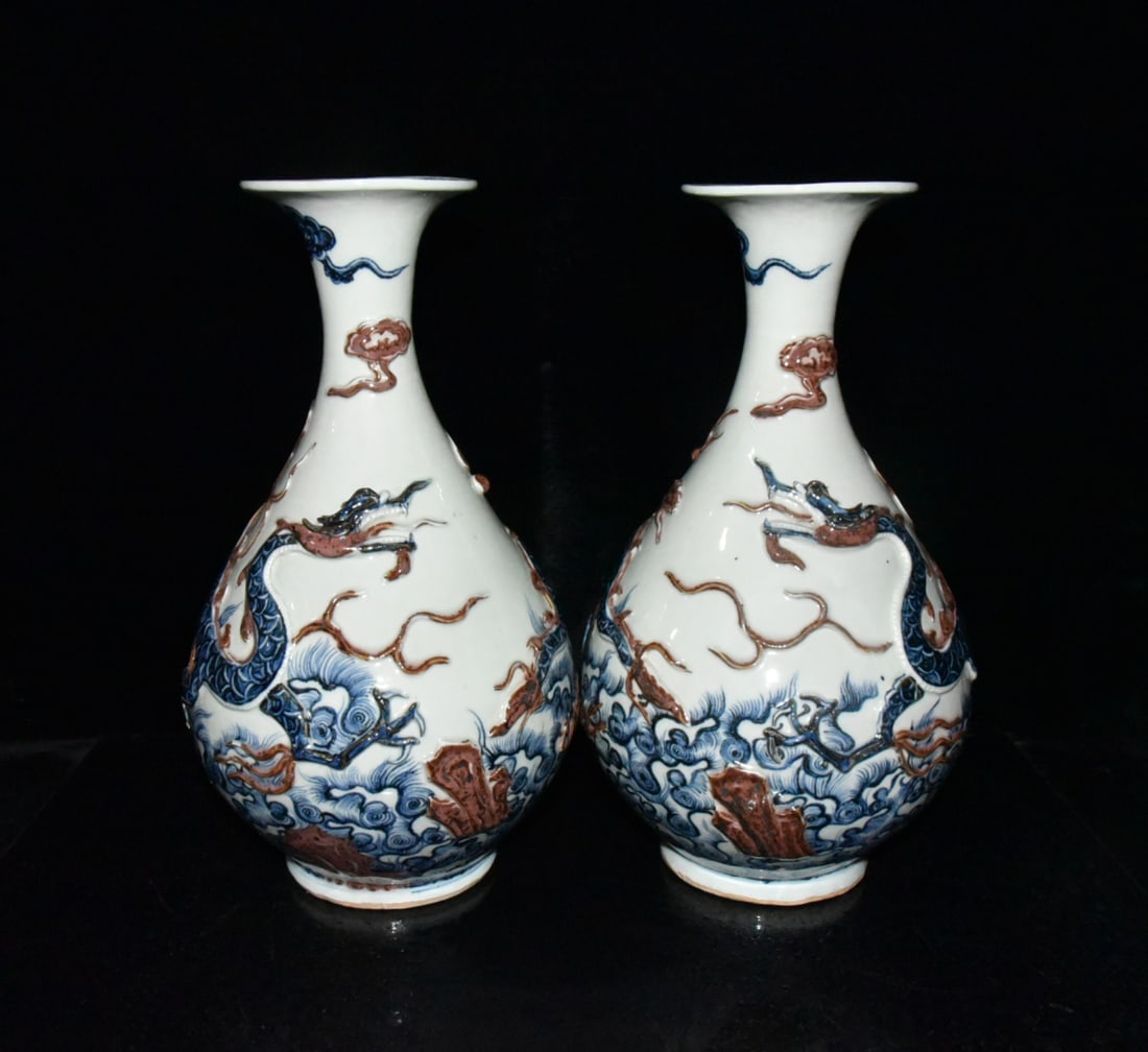 A pair of Yuan Dynasty blue and white underglaze red carved dragon and sea wave pattern Yuhuchun: pair of Yuan Dynasty blue-and-white underglaze red carved dragon and sea wave pattern Yuhuchun vases, 35??21cm Provenance:Private collection, Cliffside Park, New Jersey. Our dedicated team expertly ha
