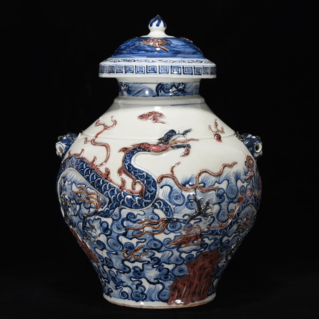 Yuan Dynasty Blue and White Underglaze Red Carved Dragon and Beast Head Jar: Yuan Dynasty blue and white underglaze red decorated dragon and animal head jar, 45 cm high, 32 cm in diameter Provenance:From a private collection in San Diego, California, USA. Our dedicated team ex