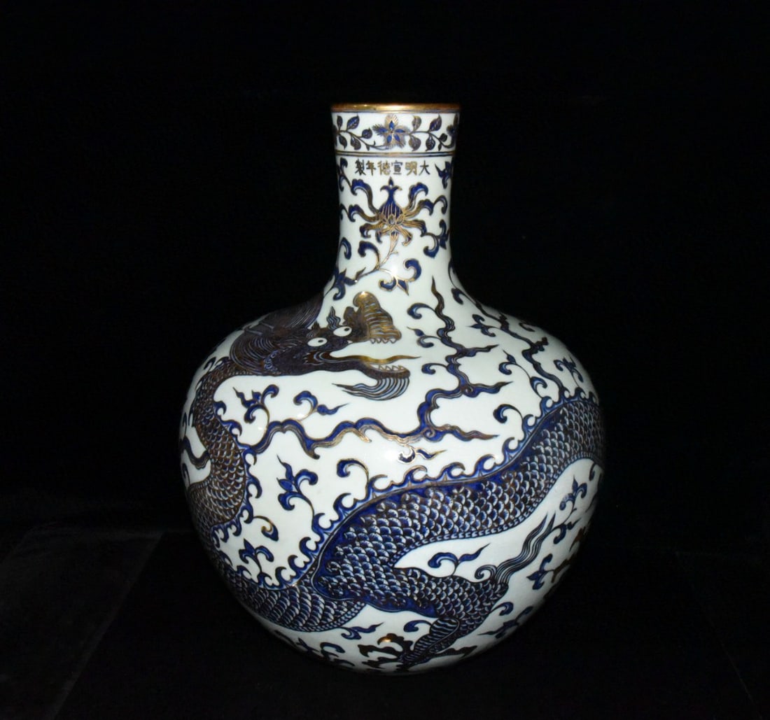 Large blue-and-white porcelain vase with inside-painted flowers and gilded dragon design from the: A pair of large celestial globe vases with blue-and-white inner-painted floral and gilt-painted dragon designs from the Xuande period of the Ming Dynasty, 50.5 x 40 cm. Provenance:Private collection,
