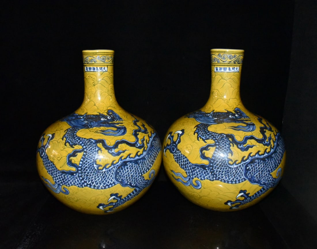 A pair of yellow-glazed blue-and-white porcelain celestial globe vases with sea dragon and wave: A pair of Ming Dynasty Yongle period yellow-glazed blue-and-white porcelain celestial globe vases with sea dragon and wave design, 42??33cm Provenance:Private collection from a professor in Yale Unive