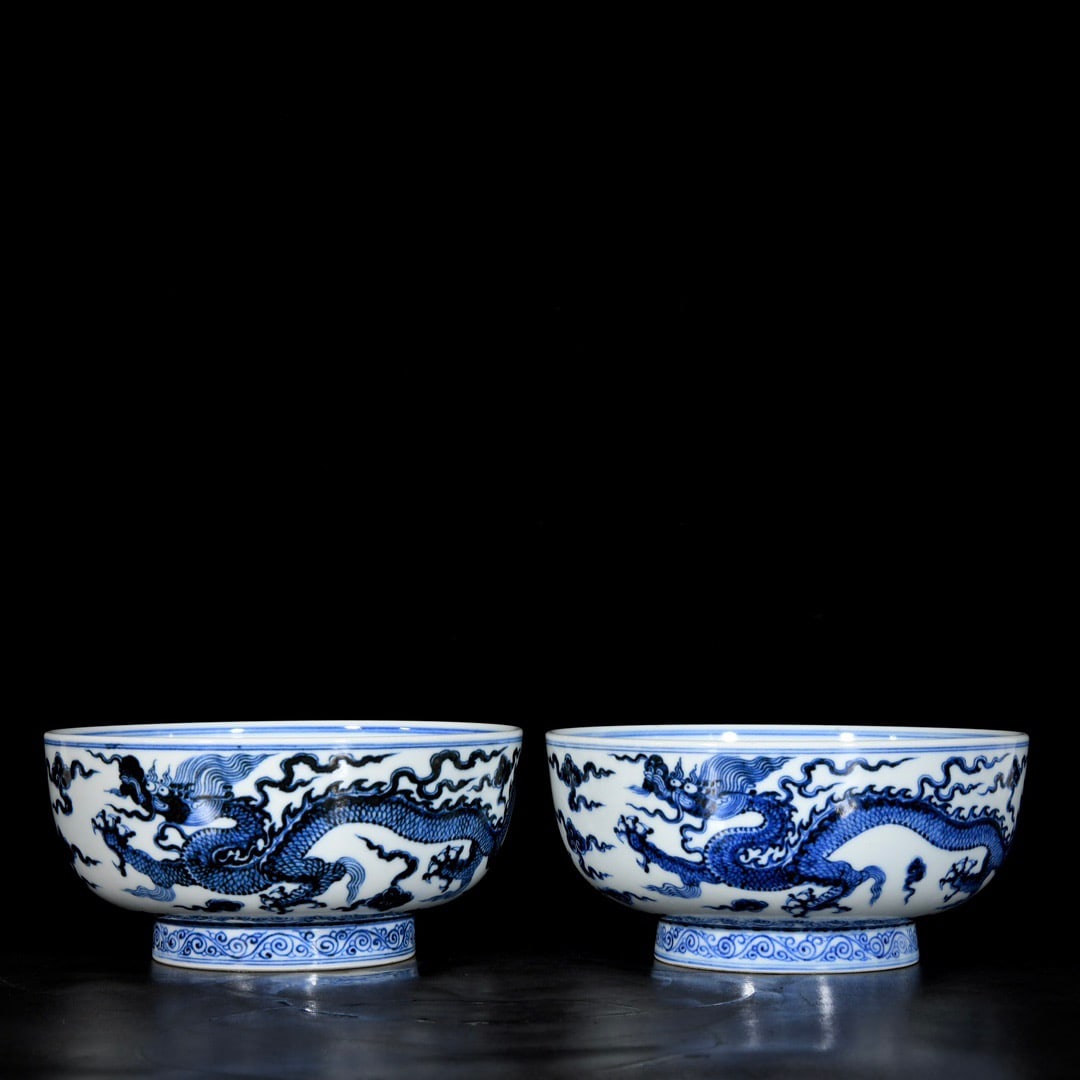 A pair of blue and white porcelain bowls with dragon and phoenix designs from the Xuande period of (1 of 9)
