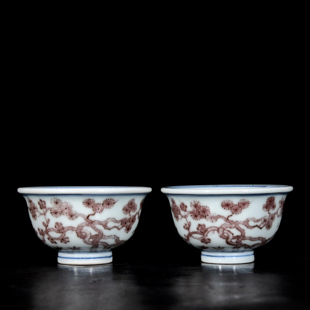 A pair of Ming Xuande underglaze red pine, bamboo and plum blossom patterned hand-pressed cups: A pair of Ming Xuande underglaze red pine, bamboo, and plum blossom patterned cups; 5.2 x 9.3 cm Provenance:Private collection , Boston, Massachusetts. Our dedicated team expertly handles both domesti