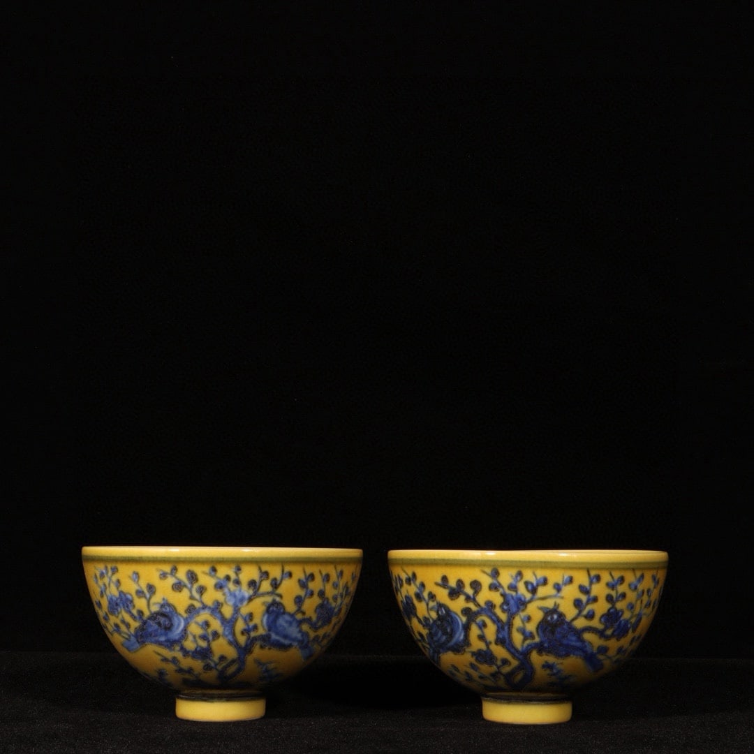 Ming Yongle Yellow-Glazed Blue and White Flower and Bird Pattern Chicken Heart Cup: A Ming Dynasty Yongle period yellow-glazed blue-and-white floral and bird design chicken-heart cup, measuring 5.5 cm in height and 9.5 cm in diameter. Provenance:Private collection , Boston, Massachus