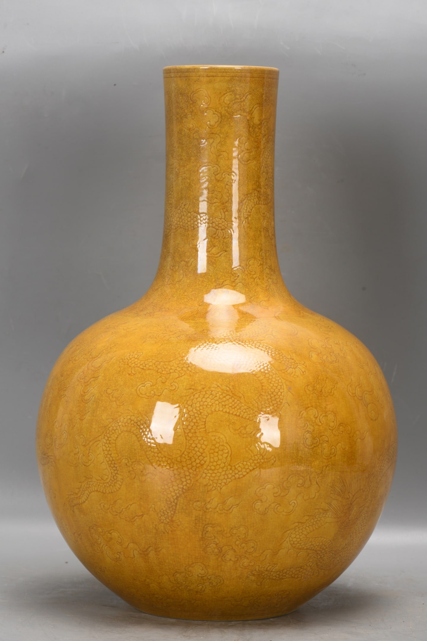 A Qing Dynasty, Yongzheng period yellow-glazed celestial globe vase with carved dragon design. (1 of 9)