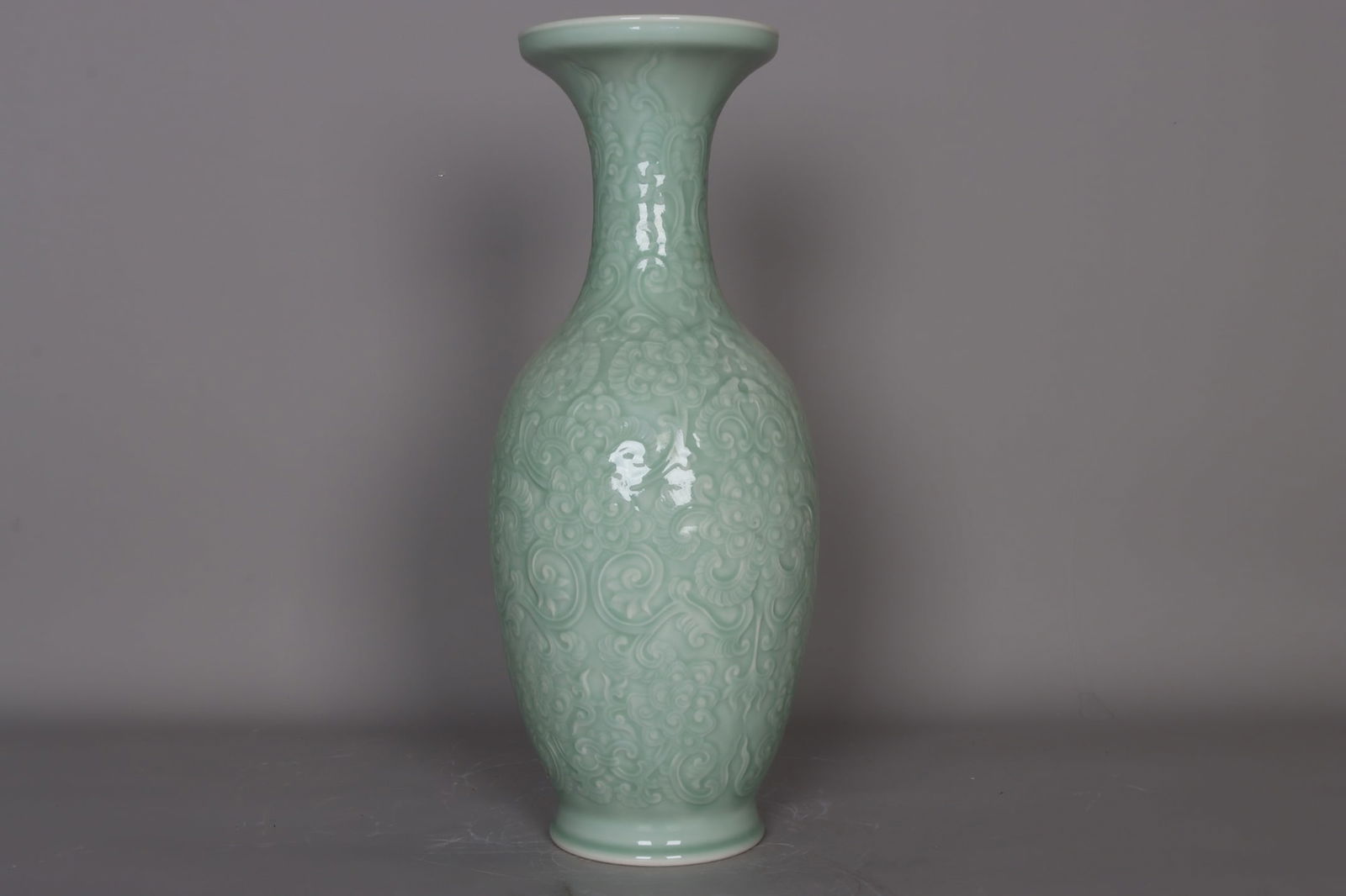 A celadon vase with carved floral design from the Qianlong period of the Qing Dynasty. (1 of 9)